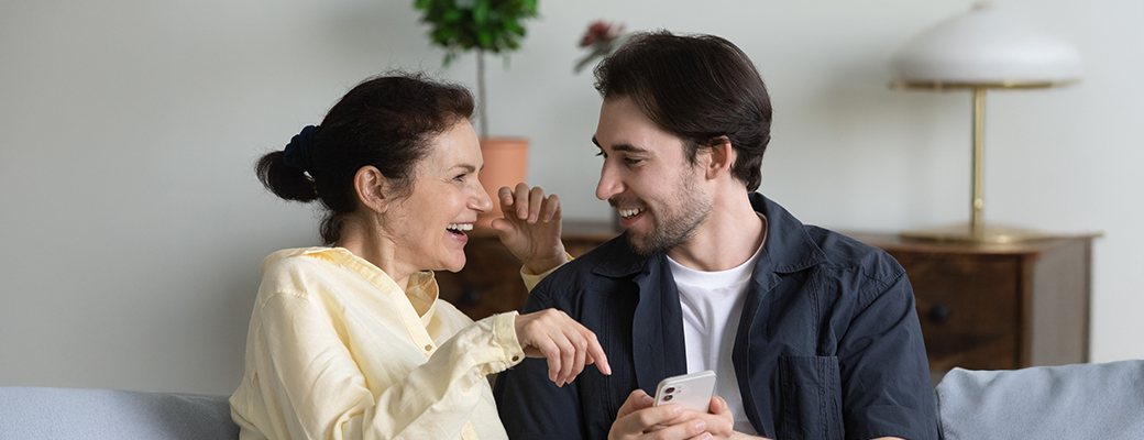 Image of man showing woman his phone to provide more information to her